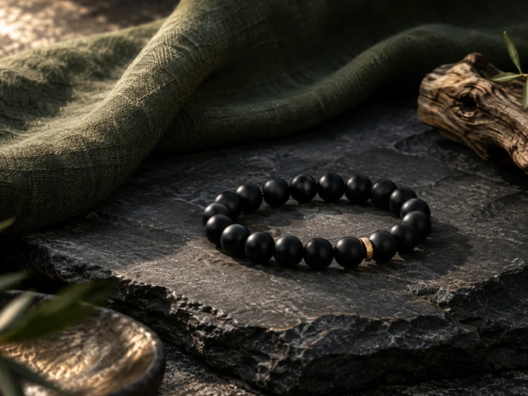 Dark stone and sandalwood bracelet on natural linen